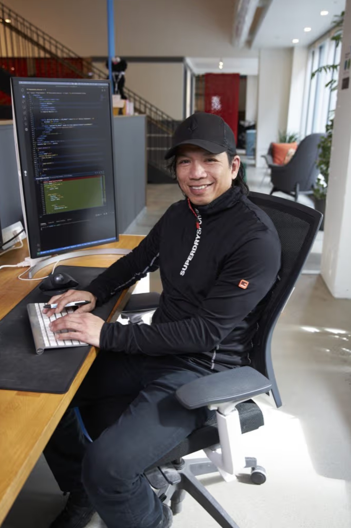 Developer working at a modern workstation with code on screen